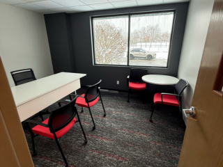 small office used as a meeting room with tables and chairs