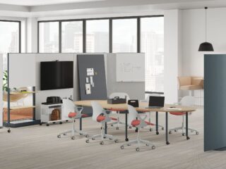 open meeting space with table, chairs, and tv on movable wall