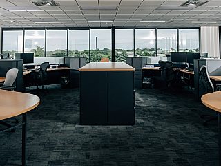 open office space with large windows and light wood desktops